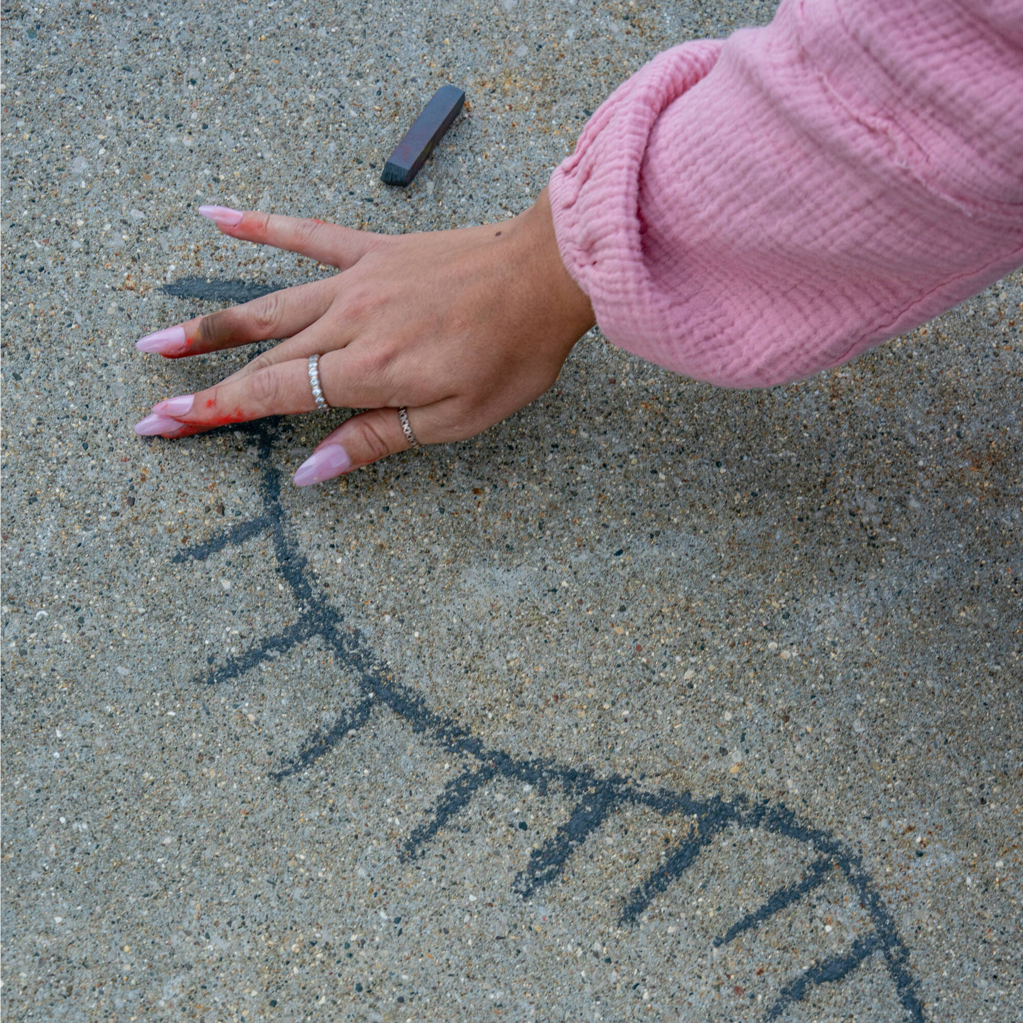 Students take part in the Chalk Art Symposium at the Mary Idema Pew Library plaza on September 18. GVSU alum and chalk artist, Emily Miller, '14 and '20, worked with students to translate research from traditional posters and oral talks to the sidewalk.